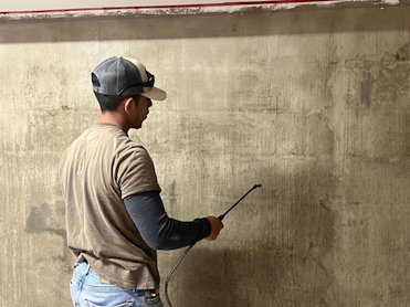 The scratch coat is sprayed with a bonding emulsion.