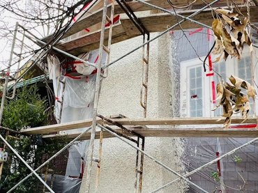 White pebble dash stucco matches the original historic chimney