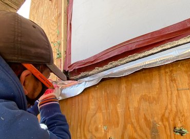Peel and stick rubber and aluminum flashing was tucked under the window jamb.
