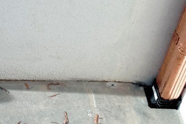 Wall was brought down tight to the slab and even sealed with caulk.