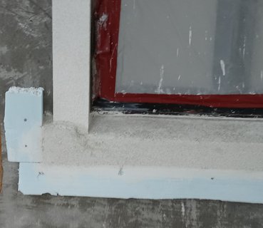 Window surrounds and details are formed and filled with white portland.