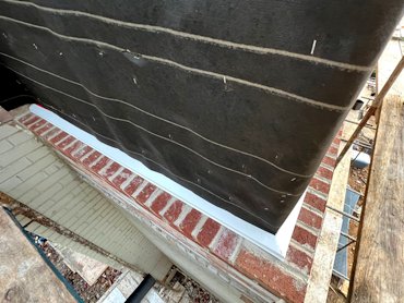 Flashing is then overlapped with tar paper.