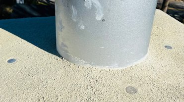 Commemorative quarters are embedded in the top of the chimney