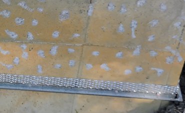 We drilled weep holes in the plaster stop