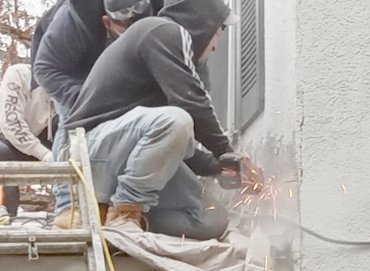 Stucco is cut off above the roof flange.