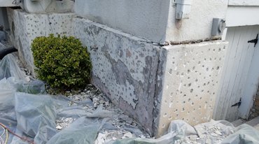 Someone put EIFS basecoat and EIFS finish over painted stucco.
