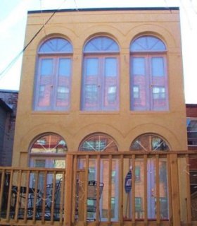 Villa style stucco townhouse in Washington, DC is colored with paint tints