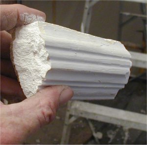 A piece of the old moulding is cut for a screed