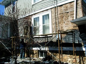 walls with years of patches torn down to the wood lath