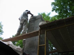 We always coat the cap we we stucco a chimney