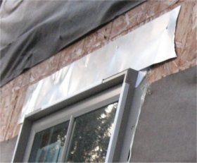 Flat sheet metal flashing was
              nailed over the top window flange