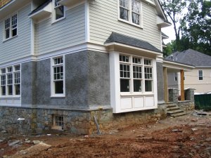 The bottom floor of
                these two new houses are pebble dash stucco