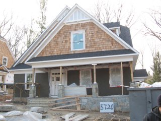 Two new pebble dash houses in an old neighborhood in Bethesda, Maryland