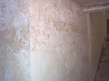 Old finish coat is stripped off of foyer