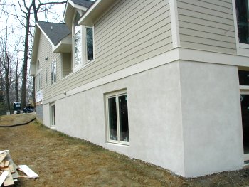 Stucco basement finished with white portland cement