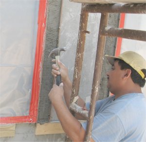 After the scratch coat on the metal lath starts to set, the nails on
the inside of the form are pulled out.
