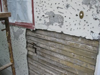 Loose stucco stripped off