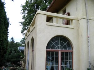 wing built about 1930 , repaired and restuccoed