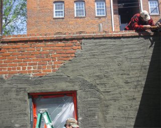 Stucco over old brick garage