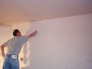 troweling white coat in dining room
