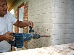 Paint is
              chipped off the brick to provide a bond for the stucco
              morta