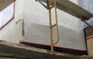 stucco was loose and buckling
