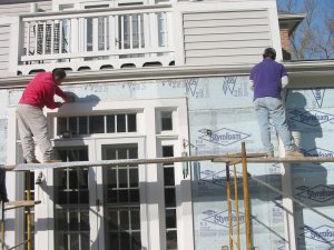 Siding off, stucco on