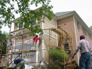 Siding off, stucco on