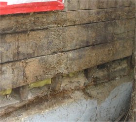 1 by sheathing was rotted where it contacted the concrete
