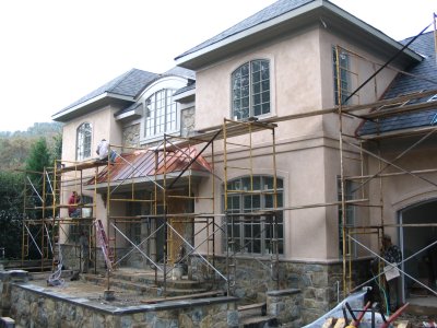 Stucco reflects warm reddish tones in the stone work.